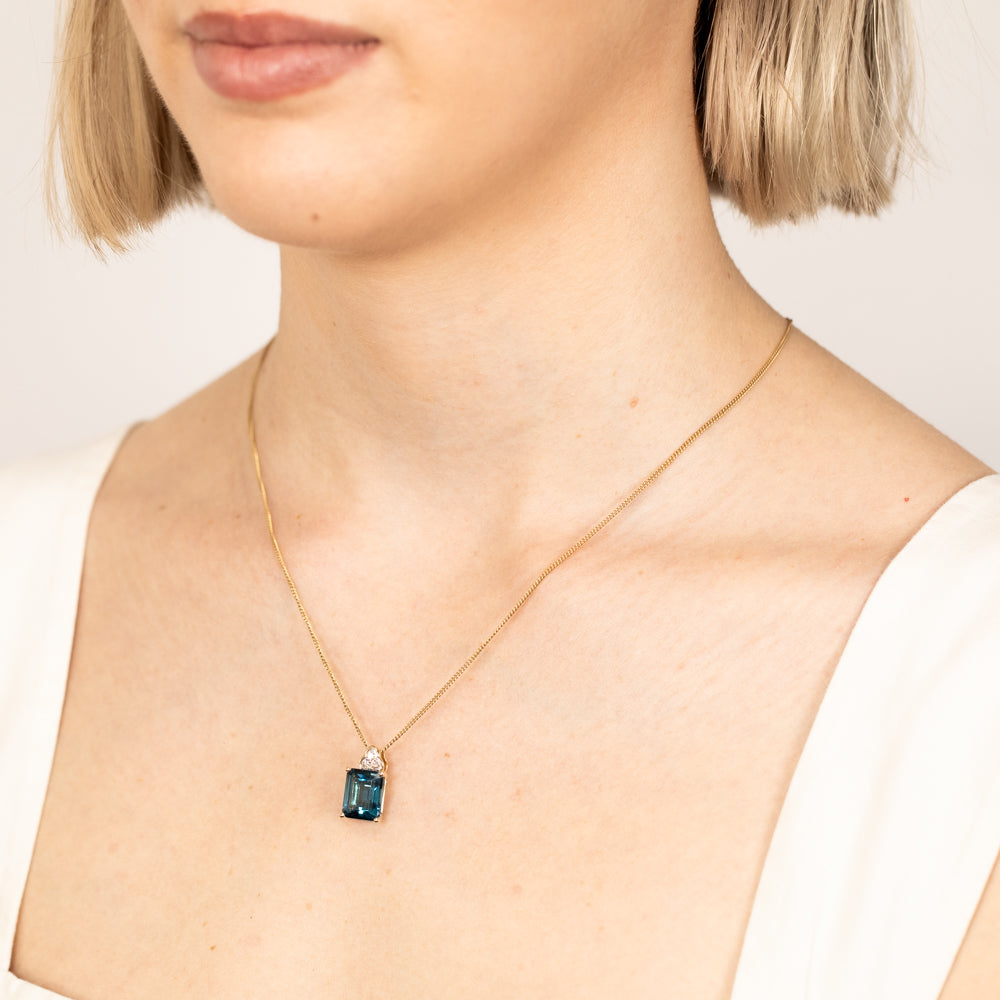 Stunning 9ct Gold Pendant Featuring a 5.6ct Emerald Cut London Blue Topaz and a 1/10 Carat Diamond