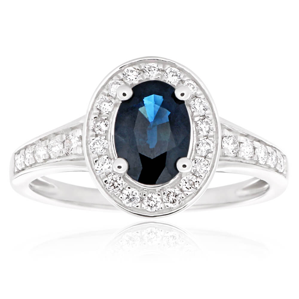 Stunning 9 Carat White Gold Engagement Ring Featuring a 1.05 Carat Natural Deep Blue Sapphire of 7x5mm and 0.26 Carat Diamonds