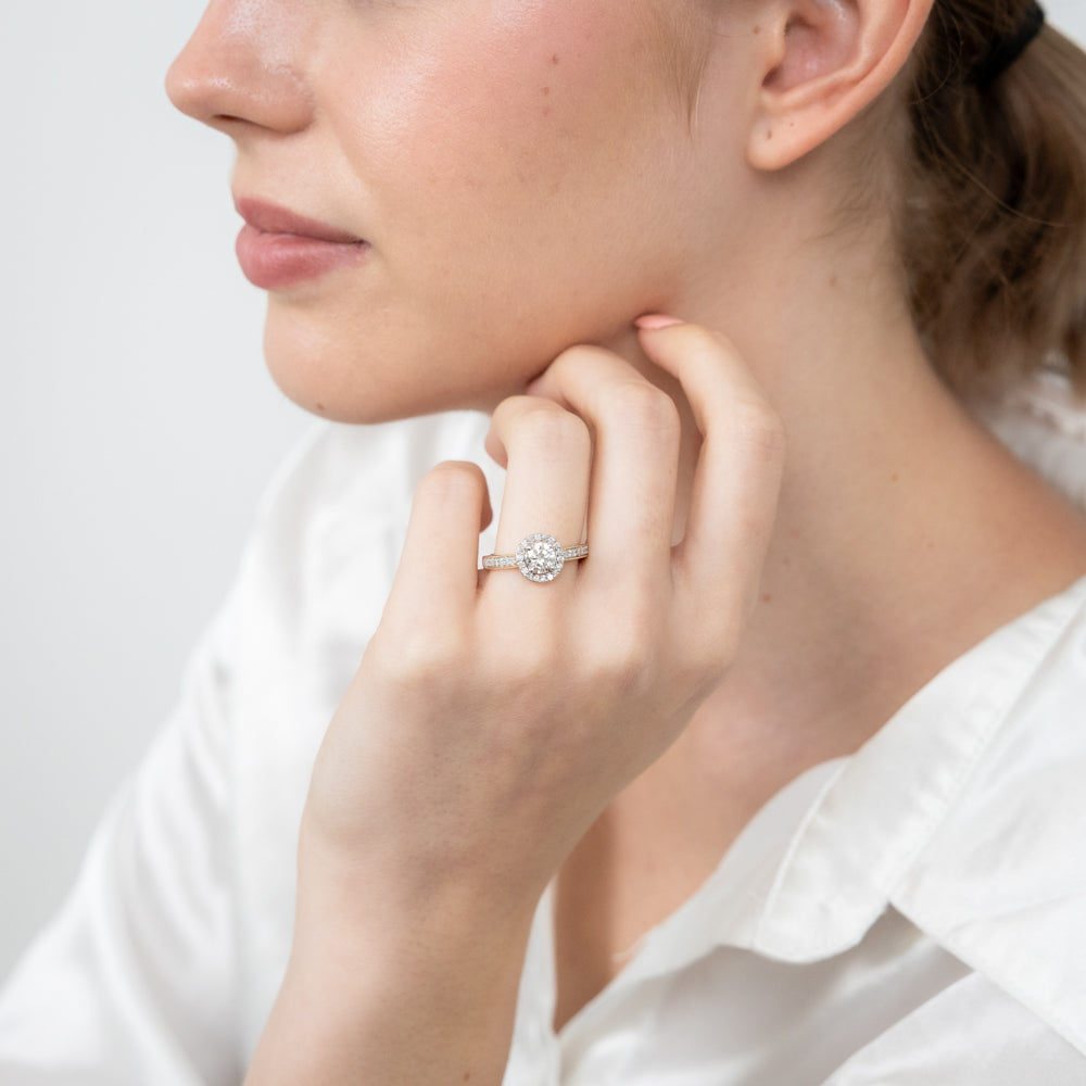 Exquisite 14 Carat Yellow Gold One-Carat Brilliant Cut Diamond Halo Solitaire Engagement Ring with Additional Diamonds on the Shank