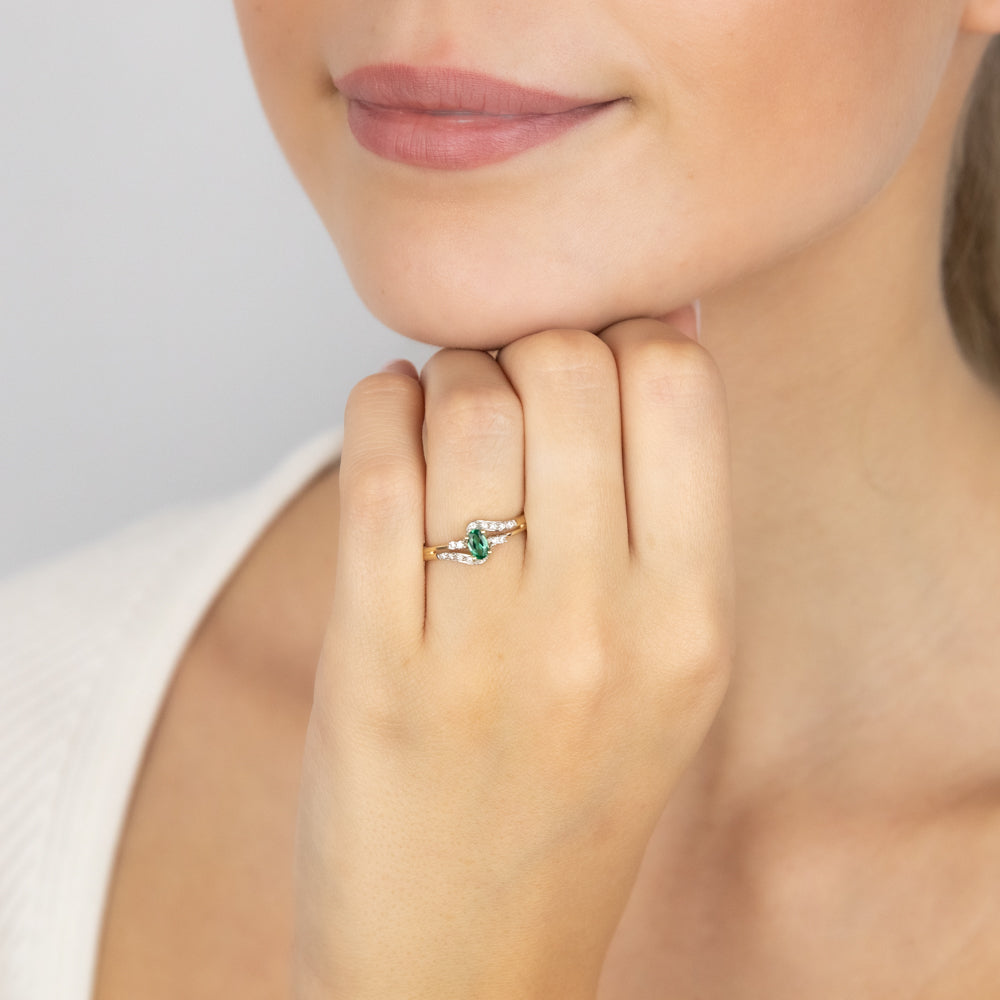 Exquisite 9 Carat Yellow Gold Ring Adorned with 0.26 Carat Created Emerald and 14 Cubic Zirconia Stones
